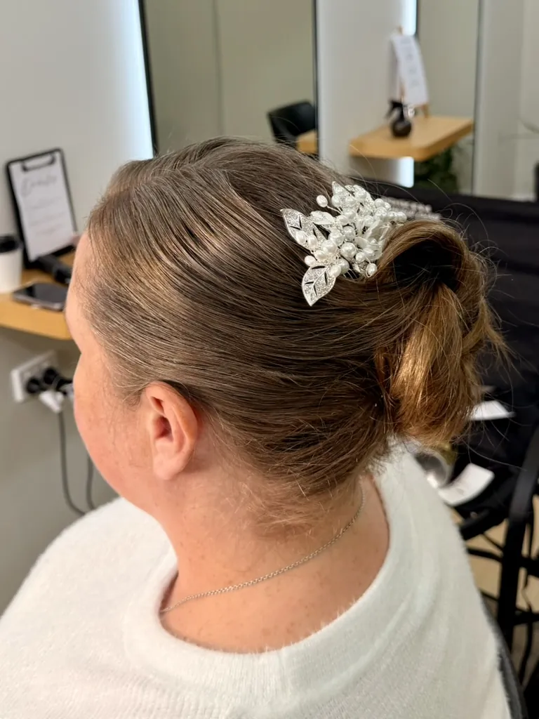 Sleek low bun with pearl hair comb